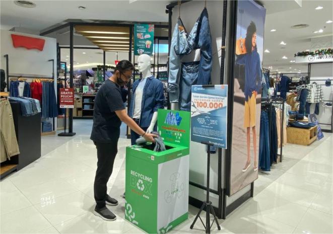 placed old clothing recycling bins with brand logos outside its stores