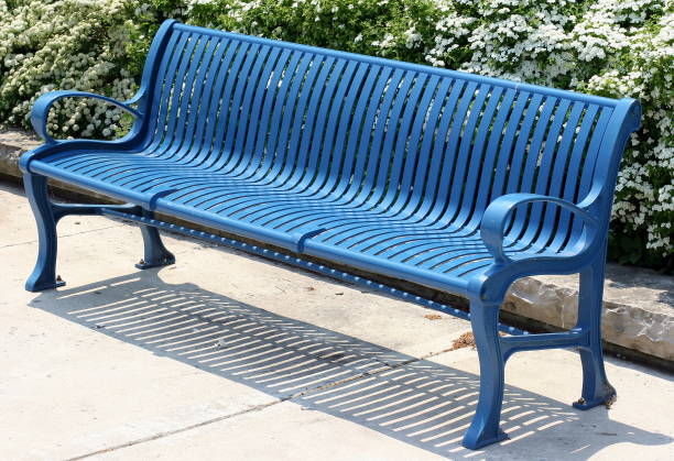 Blue metal bench on sunny day